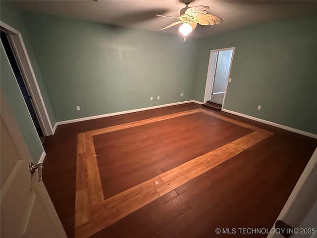 905 Brookside Dr, Durant, OK 74701 - spare room featuring a ceiling fan, dark wood-type flooring, and baseboards