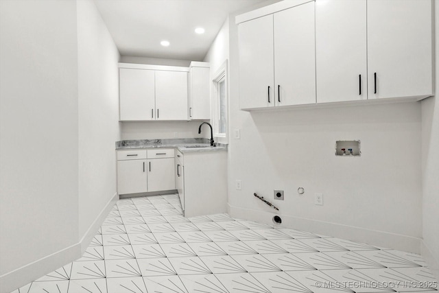 5011 E 84th St, Tulsa, OK 74137 - laundry area featuring gas dryer hookup, electric dryer hookup, baseboards, cabinet space, and washer hookup