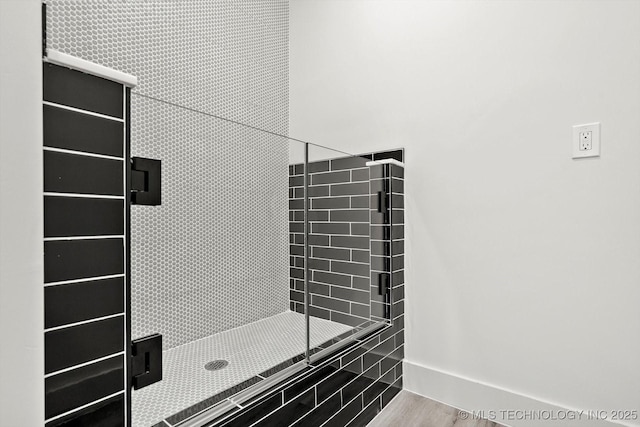 5011 E 84th St, Tulsa, OK 74137 - bathroom with a stall shower, baseboards, and wood finished floors
