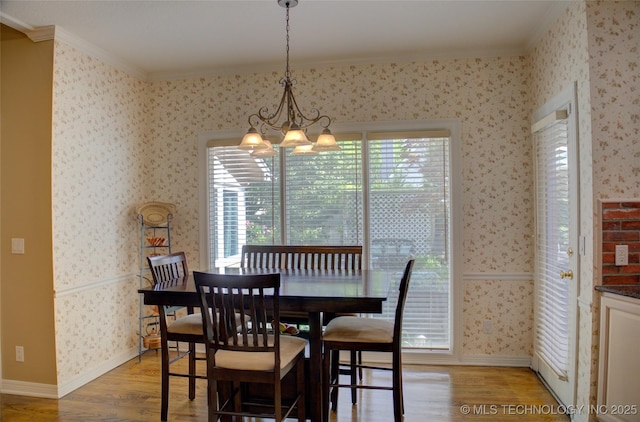 5140 E 107th Pl, Tulsa, OK 74137 - dining space featuring light wood finished floors, crown molding, wallpapered walls, a chandelier, and plenty of natural light