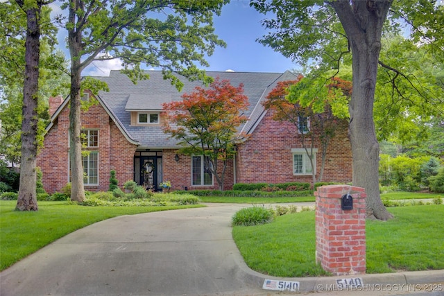 5140 E 107th Pl, Tulsa, OK 74137 - tudor home with a front yard and brick siding