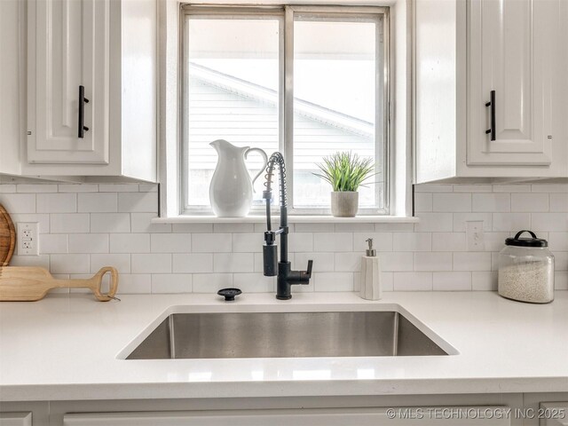 5015 S 89th E Pl, Tulsa, OK 74145 - kitchen view of white cabinets, light countertops, and decorative backsplash