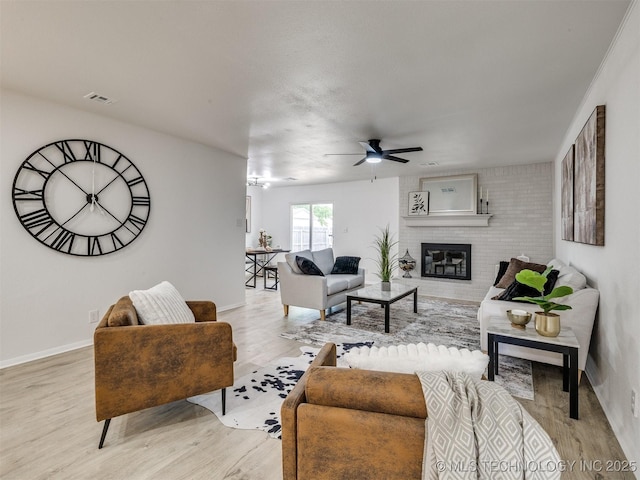 5015 S 89th E Pl, Tulsa, OK 74145 - living room with ceiling fan, light wood-type flooring, and a fireplace