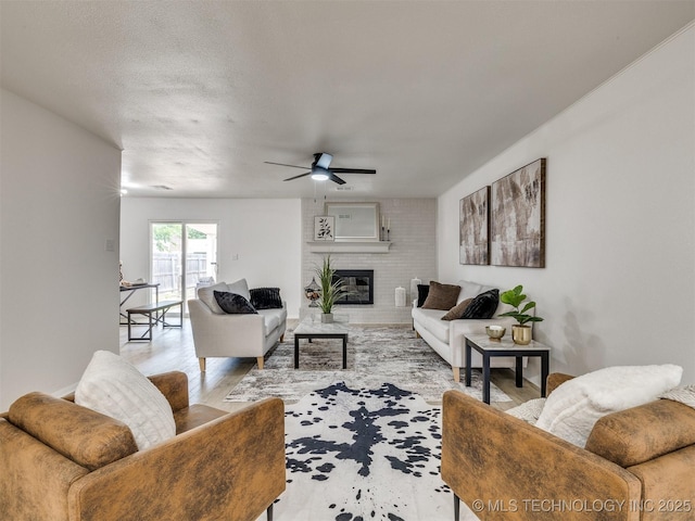 5015 S 89th E Pl, Tulsa, OK 74145 - living area with wood finished floors, ceiling fan, and a brick fireplace