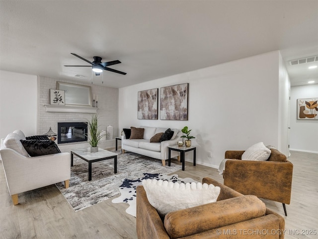 5015 S 89th E Pl, Tulsa, OK 74145 - living area with light wood-style flooring, a ceiling fan, and a fireplace