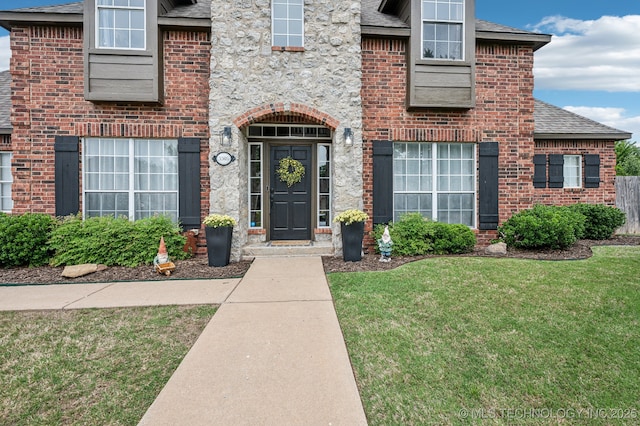 3305 N Oak Ave, Broken Arrow, OK 74012 - view of exterior entry with a lawn, roof with shingles, and brick siding