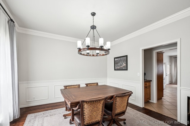 3305 N Oak Ave, Broken Arrow, OK 74012 - dining space with a chandelier, crown molding, wood finished floors, and wainscoting