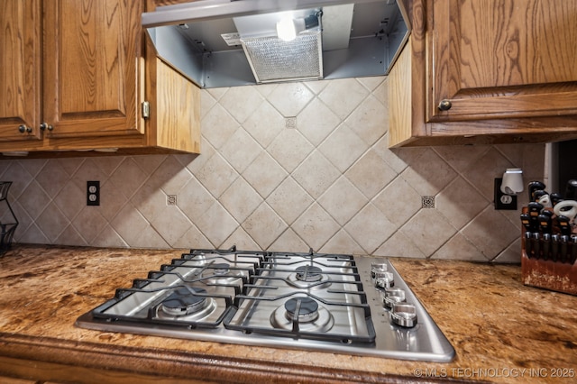 3305 N Oak Ave, Broken Arrow, OK 74012 - kitchen with range hood, stainless steel gas cooktop, brown cabinetry, and backsplash