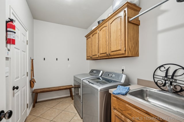 3305 N Oak Ave, Broken Arrow, OK 74012 - washroom featuring washer and dryer, light tile patterned flooring, and cabinet space
