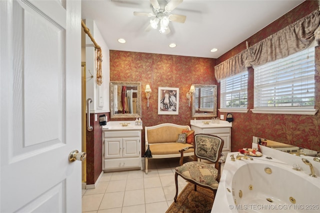 2403 S Troost Ave, Tulsa, OK 74114 - bathroom featuring wallpapered walls, a jetted tub, tile patterned flooring, a ceiling fan, and vanity