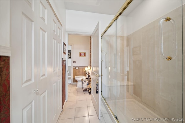 2403 S Troost Ave, Tulsa, OK 74114 - bathroom featuring tile patterned floors, toilet, and a stall shower