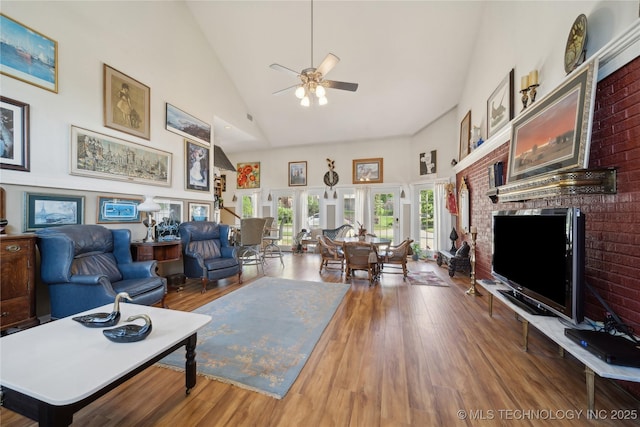 2403 S Troost Ave, Tulsa, OK 74114 - living area featuring high vaulted ceiling, a ceiling fan, wood finished floors, and a brick fireplace