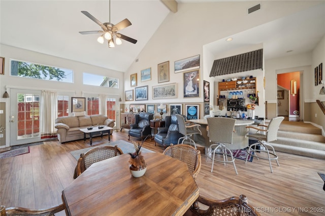 2403 S Troost Ave, Tulsa, OK 74114 - dining room with high vaulted ceiling, ceiling fan, wood finished floors, beam ceiling, and plenty of natural light