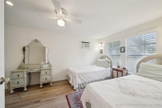 2403 S Troost Ave, Tulsa, OK 74114 - bedroom with wood finished floors, baseboards, and a ceiling fan