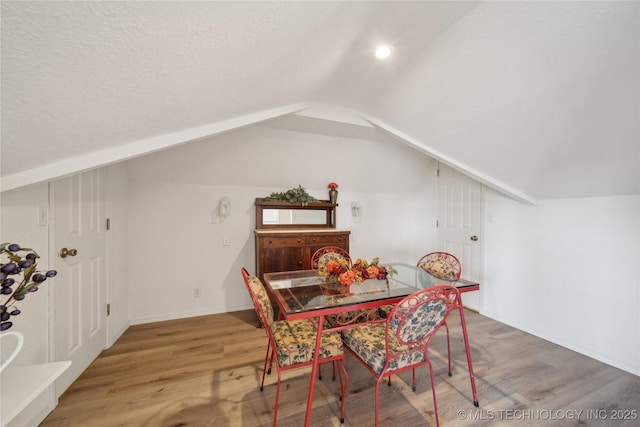 2403 S Troost Ave, Tulsa, OK 74114 - dining room featuring lofted ceiling, wood finished floors, and a textured ceiling