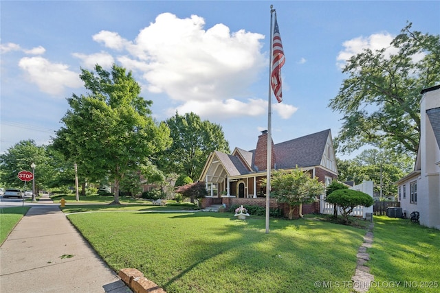 2403 S Troost Ave, Tulsa, OK 74114 - view of front of home featuring a front yard, central air condition unit, and brick siding