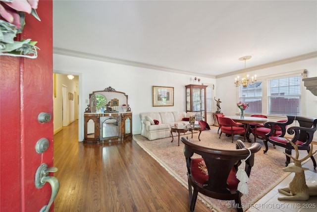 2403 S Troost Ave, Tulsa, OK 74114 - dining area with wood finished floors, a chandelier, and crown molding