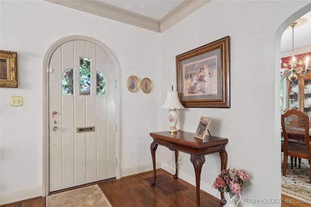 2403 S Troost Ave, Tulsa, OK 74114 - foyer entrance featuring arched walkways, healthy amount of natural light, dark wood-style flooring, baseboards, and ornamental molding