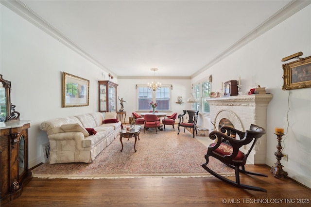 2403 S Troost Ave, Tulsa, OK 74114 - living area featuring a fireplace, a chandelier, wood finished floors, crown molding, and baseboards