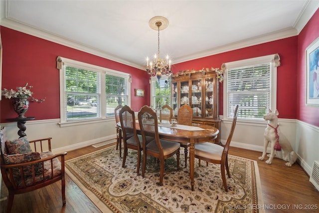 2403 S Troost Ave, Tulsa, OK 74114 - dining space with a chandelier, wood finished floors, ornamental molding, and baseboards
