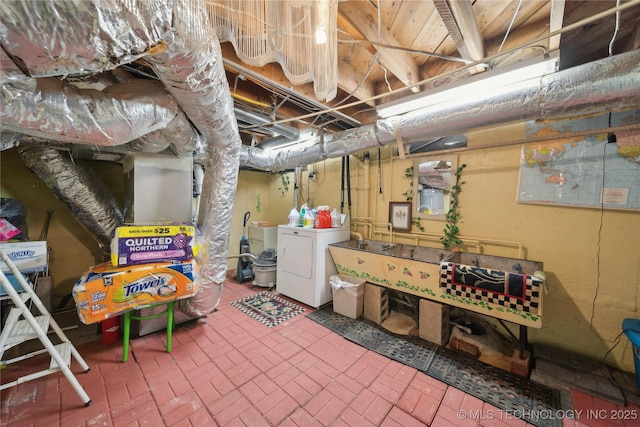 2403 S Troost Ave, Tulsa, OK 74114 - unfinished below grade area with washer / clothes dryer and brick patterned floors