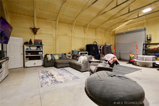6854 Delores Dr, Sulphur, OK 73086 - living room with concrete floors, vaulted ceiling, and a garage