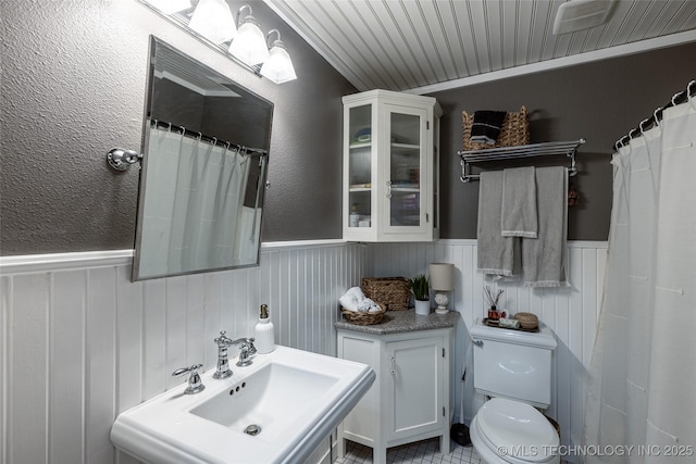 11787 S 4243rd Rd, Chelsea, OK 74016 - bathroom featuring a wainscoted wall, toilet, and a sink