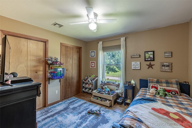 11787 S 4243rd Rd, Chelsea, OK 74016 - bedroom with multiple closets, wood finished floors, and ceiling fan