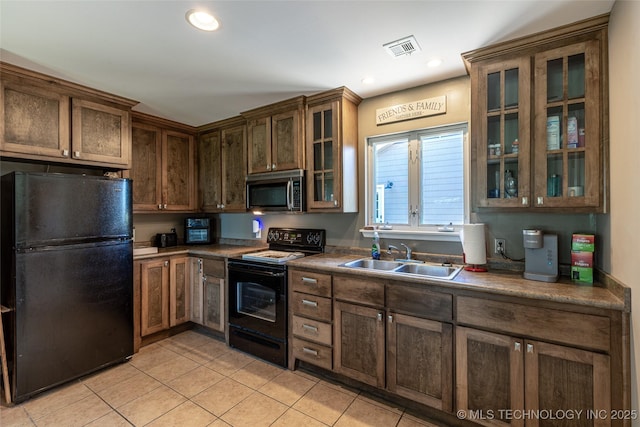11787 S 4243rd Rd, Chelsea, OK 74016 - kitchen with black appliances, a sink, light tile patterned flooring, glass insert cabinets, and recessed lighting