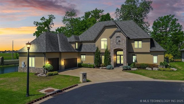 12014 S Kingston Pl, Tulsa, OK 74137 - french country home featuring stucco siding, stone siding, and an attached garage
