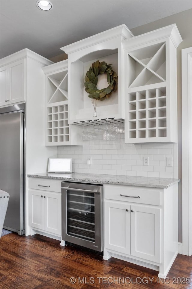 12014 S Kingston Pl, Tulsa, OK 74137 - indoor dry bar with stainless steel built in fridge, beverage cooler, tasteful backsplash, dark wood finished floors, and recessed lighting