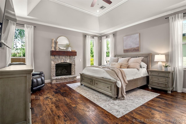 12014 S Kingston Pl, Tulsa, OK 74137 - bedroom with multiple windows, dark wood-style floors, a stone fireplace, crown molding, and recessed lighting