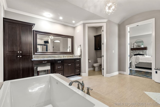 12014 S Kingston Pl, Tulsa, OK 74137 - ensuite bathroom featuring baseboards, toilet, a bathtub, vanity, and ornamental molding