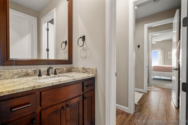 12014 S Kingston Pl, Tulsa, OK 74137 - bathroom with vanity, wood finished floors, and baseboards