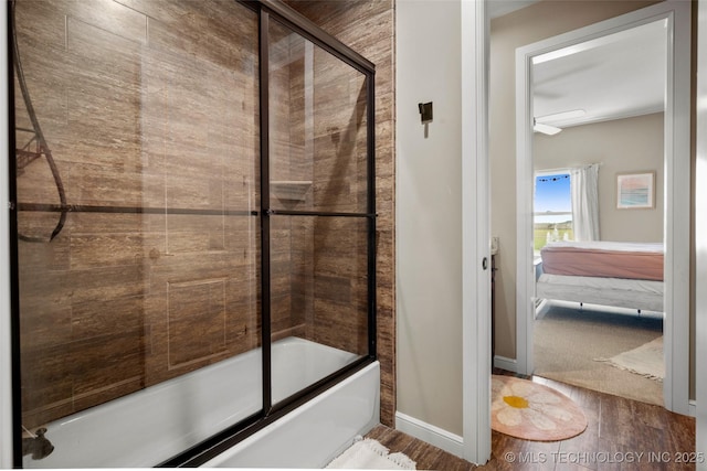 12014 S Kingston Pl, Tulsa, OK 74137 - full bath with wood finished floors, bath / shower combo with glass door, baseboards, and connected bathroom