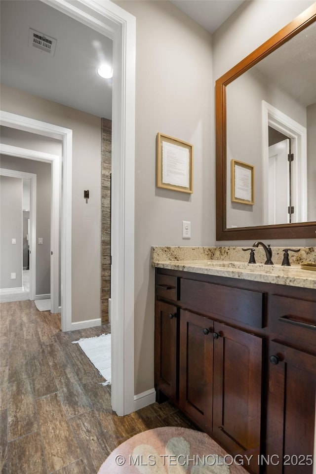 12014 S Kingston Pl, Tulsa, OK 74137 - bathroom featuring wood finished floors, vanity, and baseboards