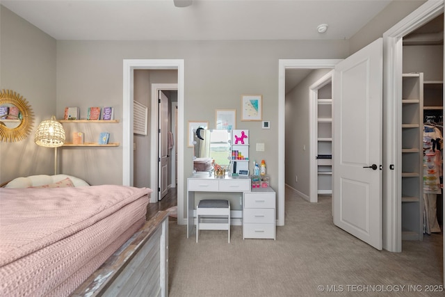 12014 S Kingston Pl, Tulsa, OK 74137 - bedroom with light carpet and a walk in closet