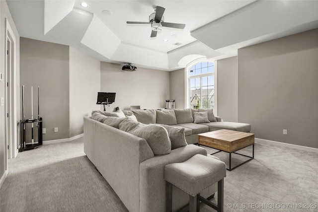 12014 S Kingston Pl, Tulsa, OK 74137 - living room featuring a raised ceiling, light colored carpet, ceiling fan, and recessed lighting