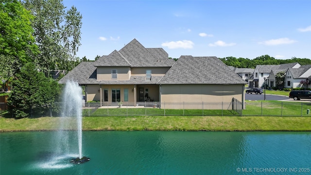12014 S Kingston Pl, Tulsa, OK 74137 - rear view of house with stucco siding, a water view, and roof with shingles