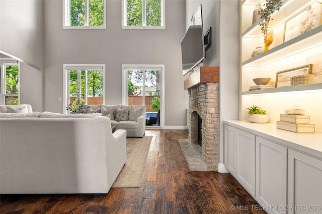 12014 S Kingston Pl, Tulsa, OK 74137 - living room with a high ceiling, a fireplace, dark wood-style floors, plenty of natural light, and baseboards