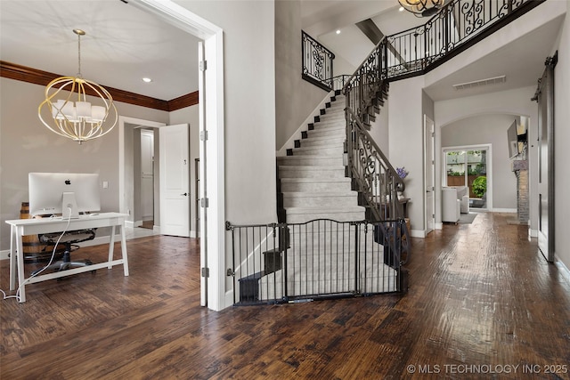 12014 S Kingston Pl, Tulsa, OK 74137 - entrance foyer with a chandelier, arched walkways, hardwood / wood-style flooring, baseboards, and a towering ceiling