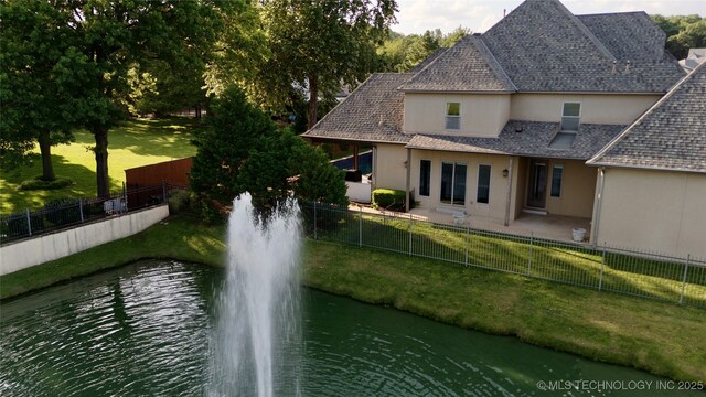 12014 S Kingston Pl, Tulsa, OK 74137 - back of house with stucco siding and a water view