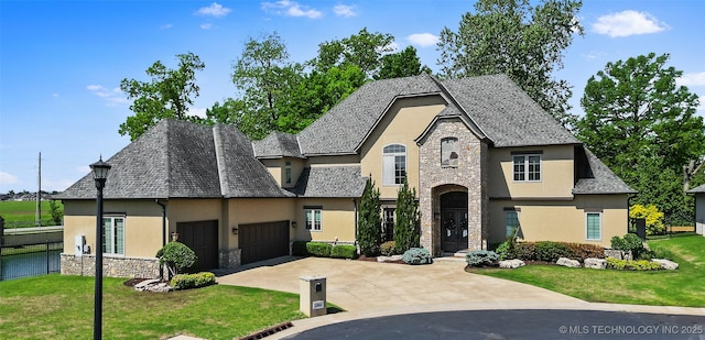 12014 S Kingston Pl, Tulsa, OK 74137 - french country inspired facade featuring stone siding, stucco siding, an attached garage, concrete driveway, and a front yard