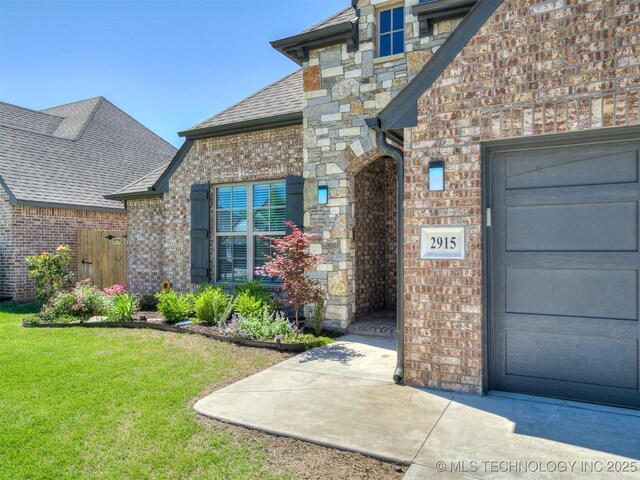 2915 E Rockford Pl, Broken Arrow, OK 74014 - entrance to property with brick siding, a lawn, roof with shingles, and an attached garage