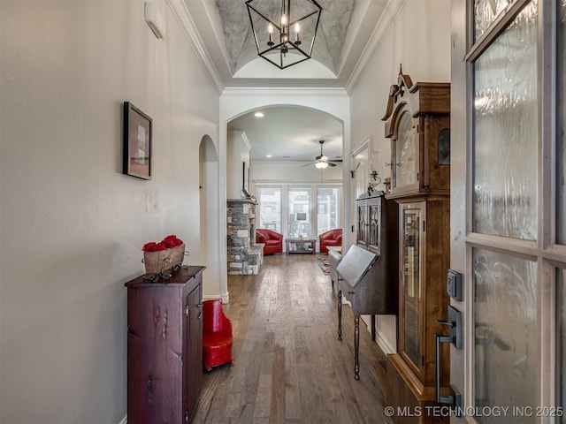 2915 E Rockford Pl, Broken Arrow, OK 74014 - foyer entrance with arched walkways, crown molding, wood finished floors, ceiling fan, and a chandelier