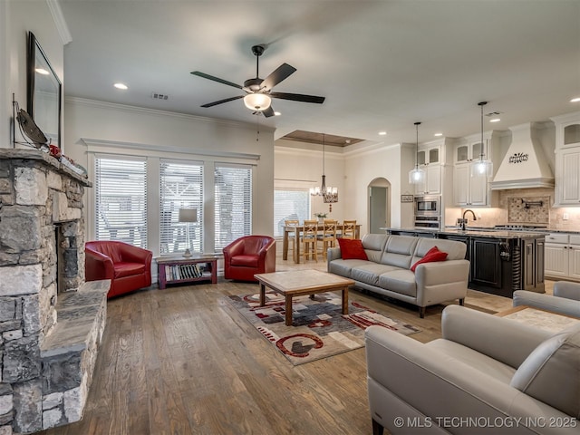 2915 E Rockford Pl, Broken Arrow, OK 74014 - living area with a ceiling fan, wood finished floors, a chandelier, crown molding, and recessed lighting