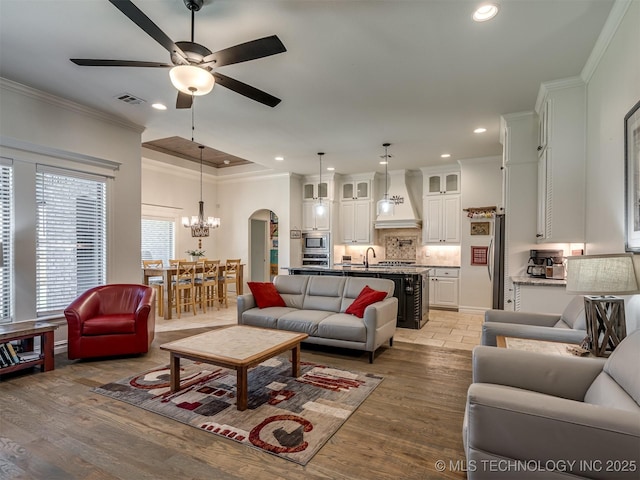 2915 E Rockford Pl, Broken Arrow, OK 74014 - living room featuring ceiling fan, a chandelier, recessed lighting, ornamental molding, and light wood finished floors