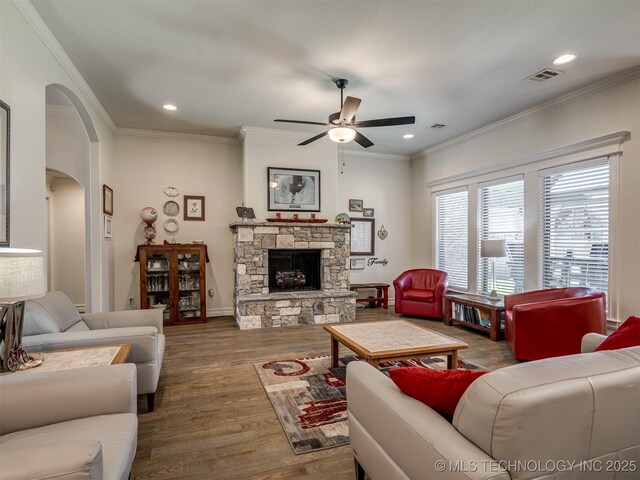 2915 E Rockford Pl, Broken Arrow, OK 74014 - living room with a ceiling fan, arched walkways, wood finished floors, crown molding, and a fireplace