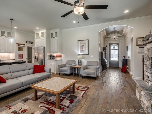 2915 E Rockford Pl, Broken Arrow, OK 74014 - living room with arched walkways, a ceiling fan, dark wood finished floors, ornamental molding, and recessed lighting
