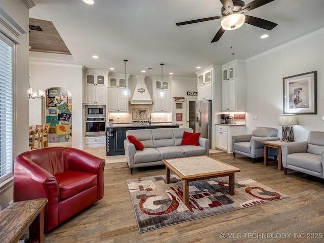 2915 E Rockford Pl, Broken Arrow, OK 74014 - living area featuring recessed lighting, ceiling fan, light wood finished floors, ornamental molding, and a chandelier